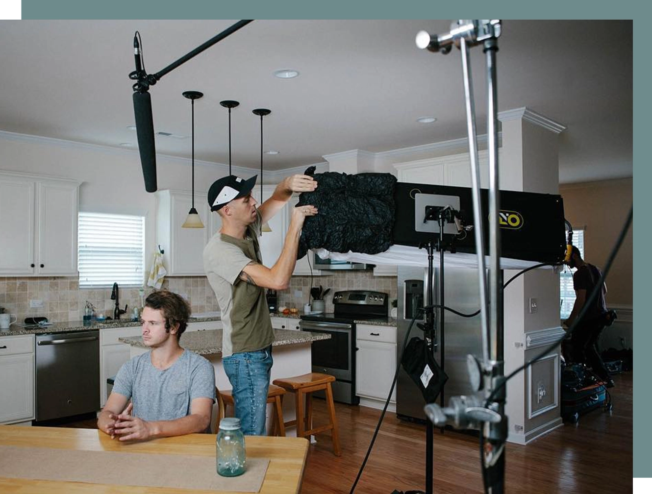 A man standing in front of another man holding up a camera.