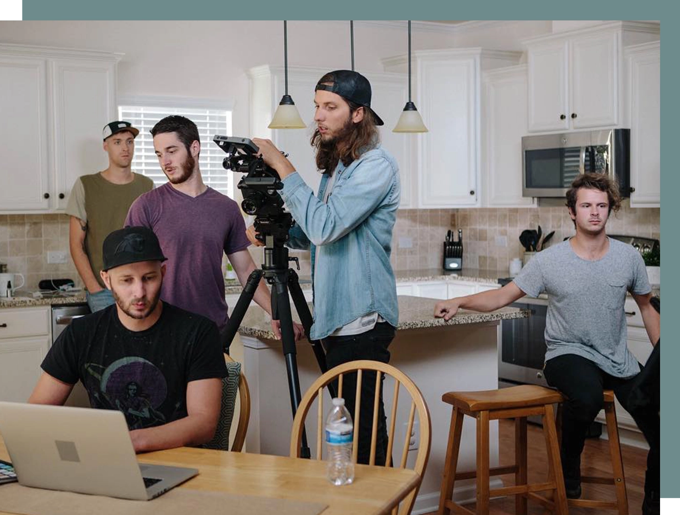 A group of men standing around a table.