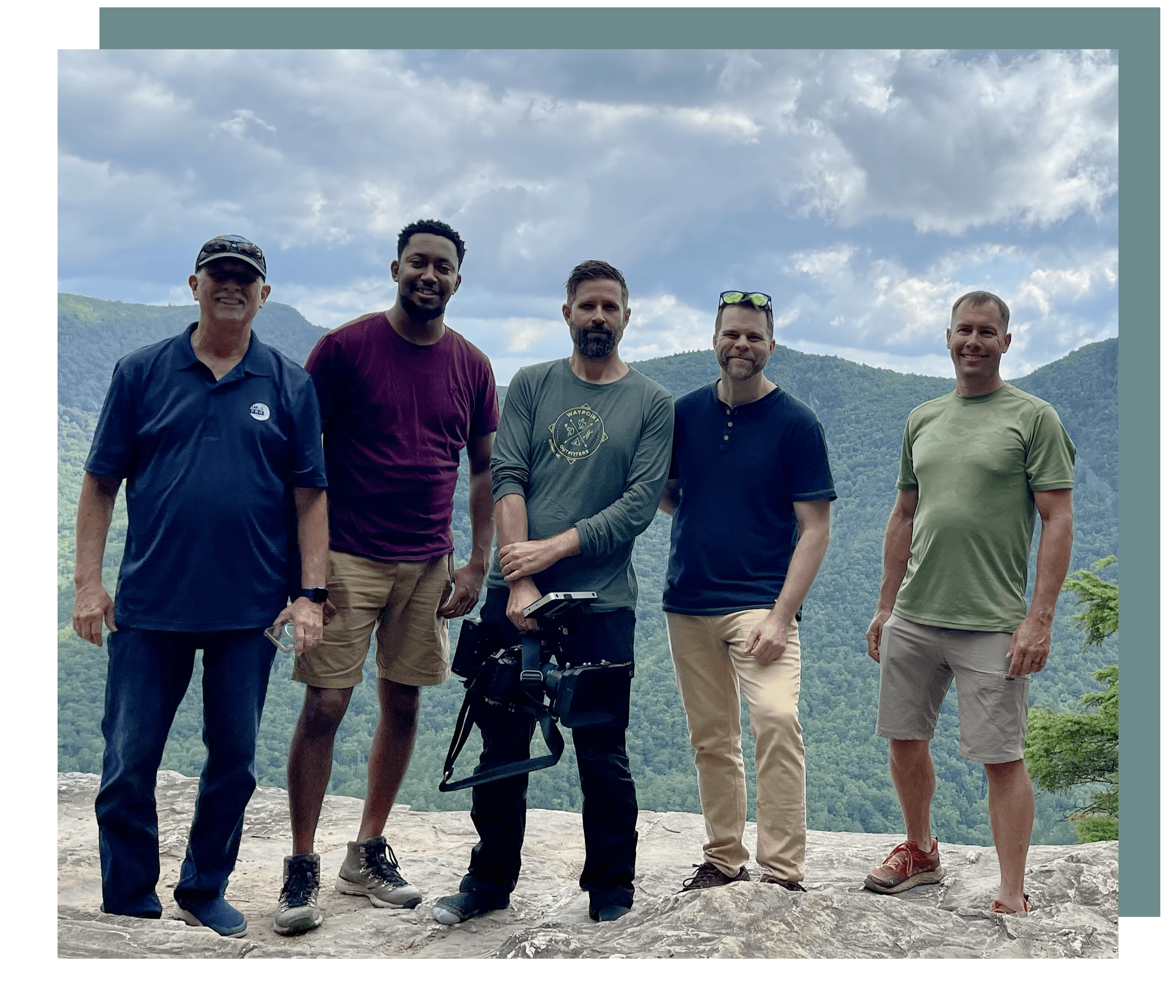 A group of men standing on top of a hill.